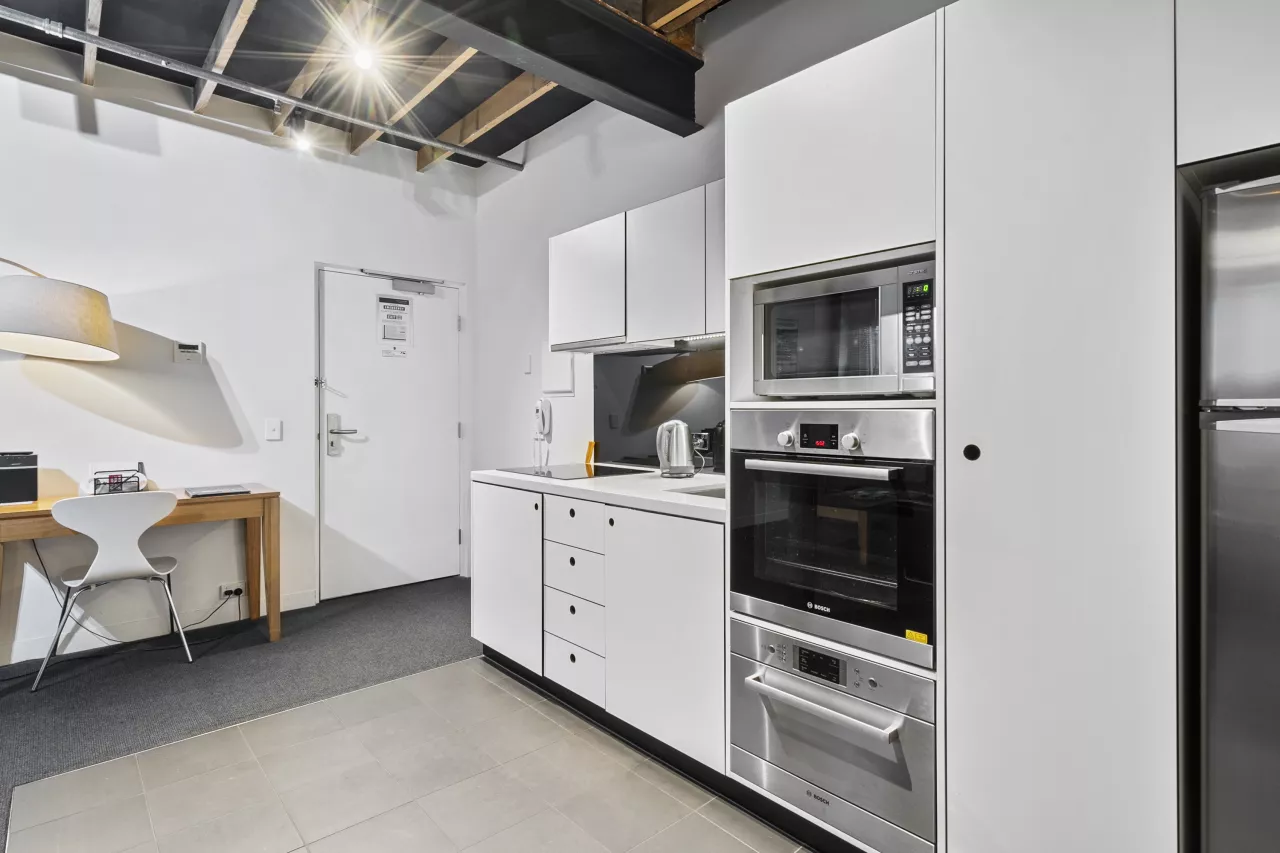 The kitchen area inside a 1 Bedroom Apartment
